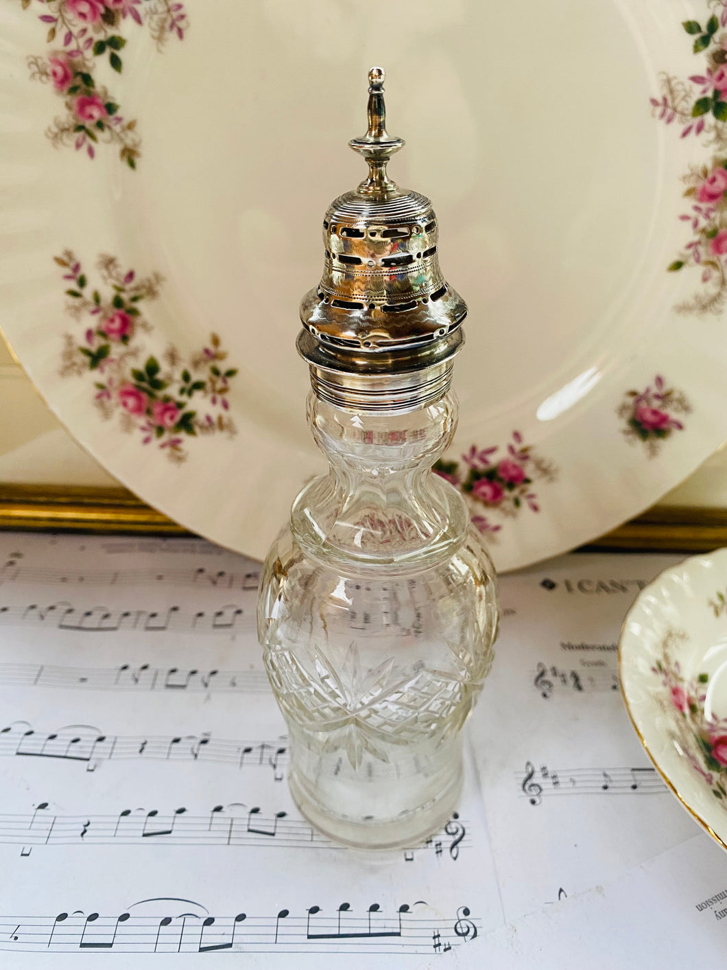 Vintage cut glass bottle with silver plated top