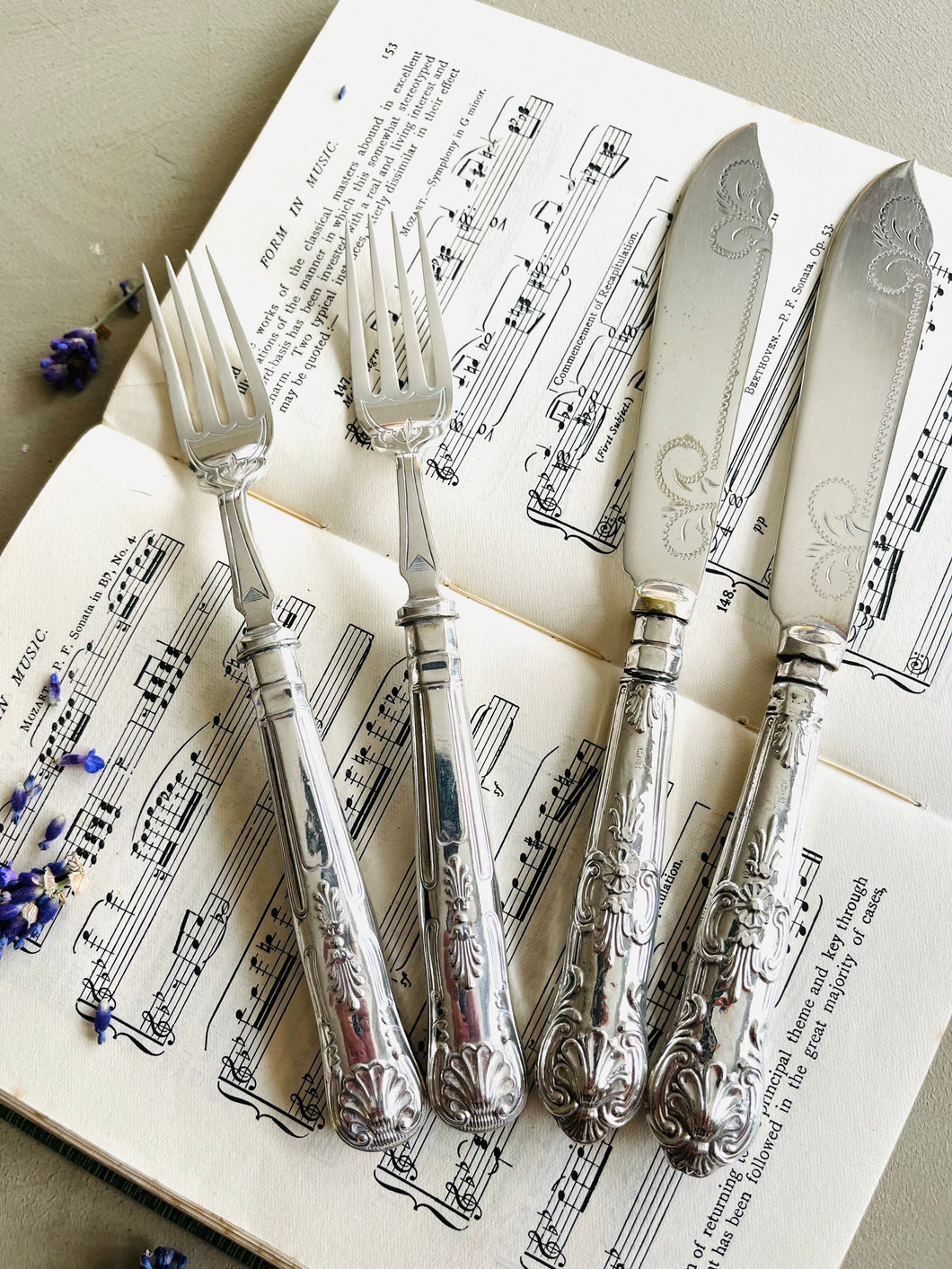 Pair of silver plated engraved fish knives and forks